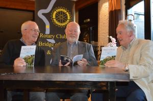 Clive Wright with his book, Faces of the Rock, with President elect David Chisholm, left and Ken Murray, right.